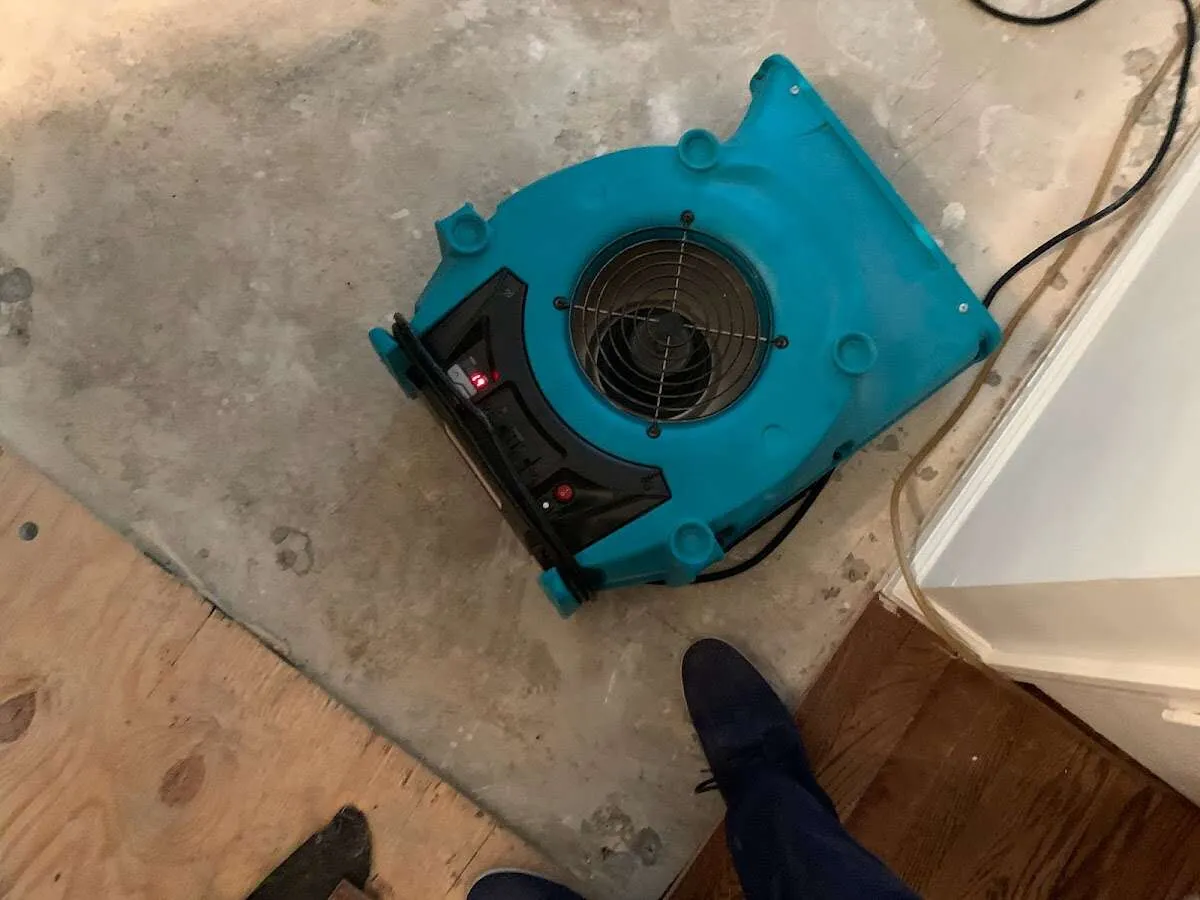Air mover drying subfloor during Commercial Water Damage Restoration in Placerville